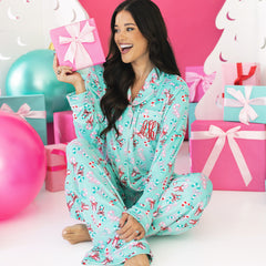 girl wearing personalize merry mint softspun pajama set with present