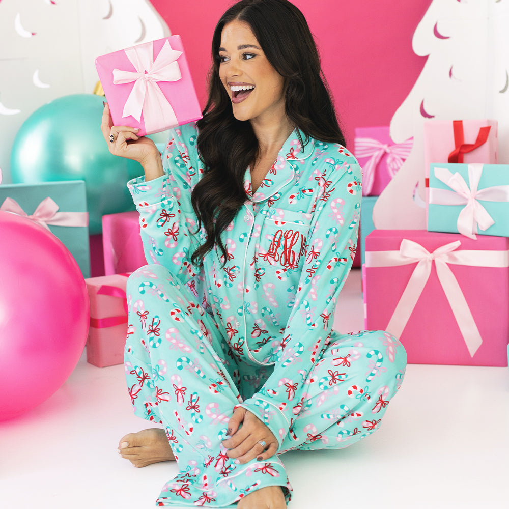 girl wearing personalize merry mint softspun pajama set with present