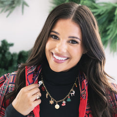 girl wearing personalized christmas charm necklace in red and green 