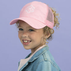 girl wearing pink monogrammed camo trucker hat 
