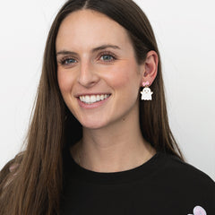 girl wearing pink white ghost earrings 