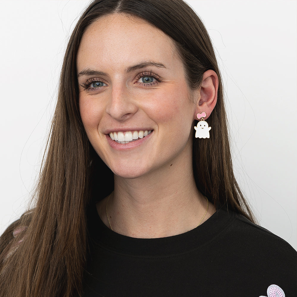 girl wearing pink white ghost earrings 