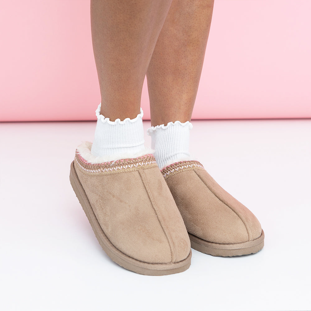 girl wearing ruffle edge socks in pink moccasins