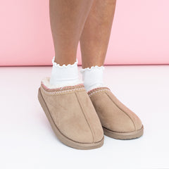 girl wearing ruffle edge socks in pink moccasins