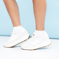 girl wearing ruffle edge socks in sneakers