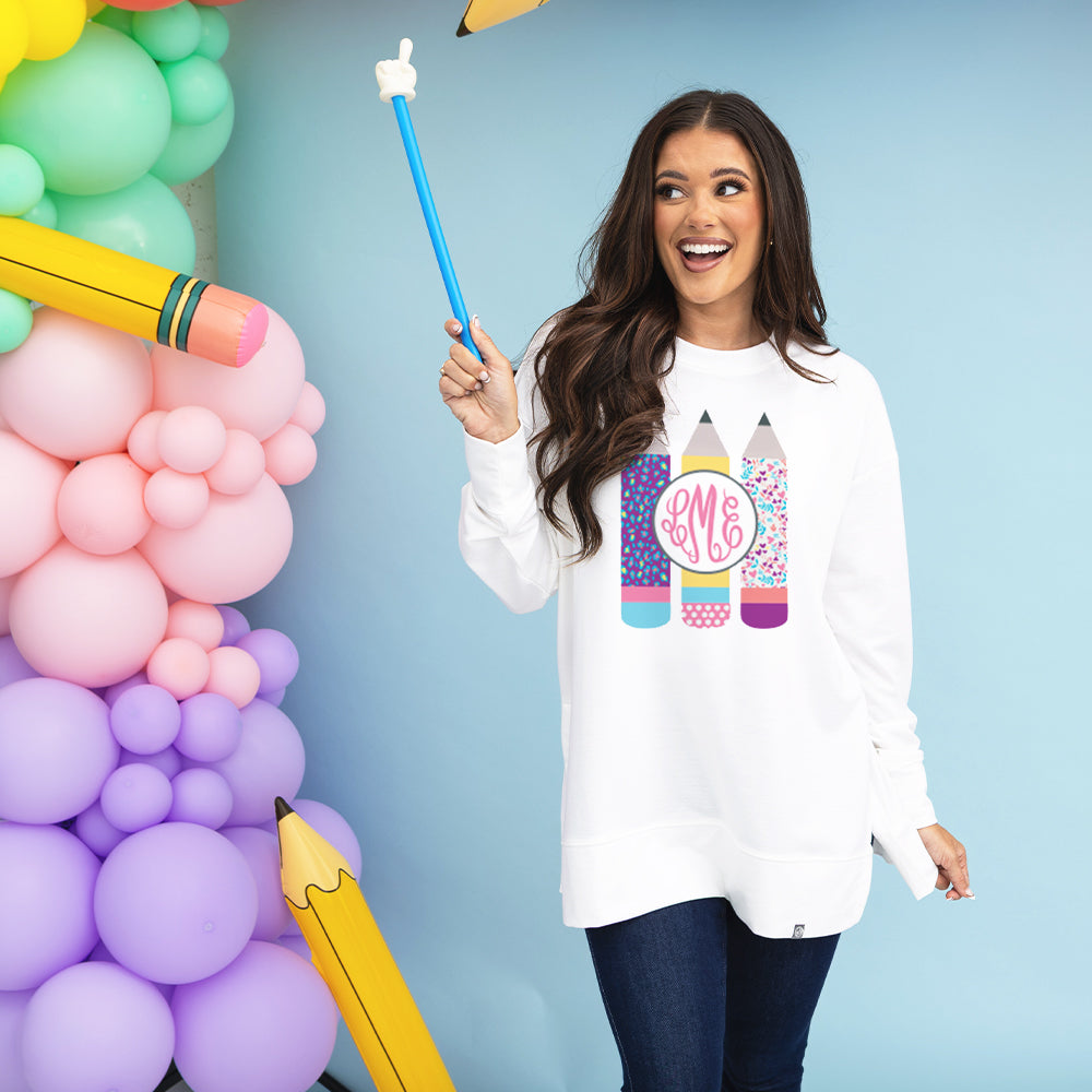 girl wearing teacher sweatshirt holding pointer