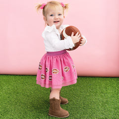 girl wearing tutu skirt in pink sequin footballs 