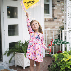 girl with back to school signs in twirl dress in ABC blooms 