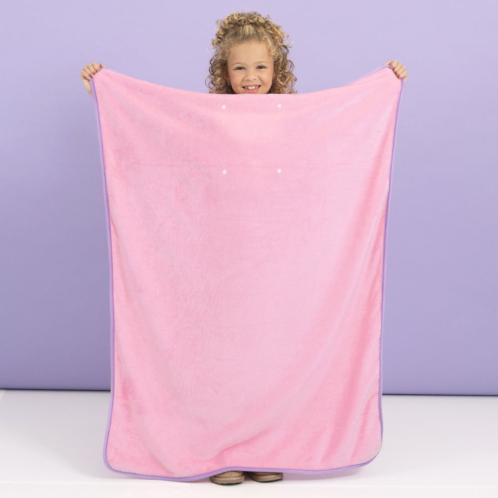 girl with personalized kids travel blanket unpacked 