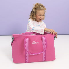 girl zipping pink punch monogrammed weekend bag 