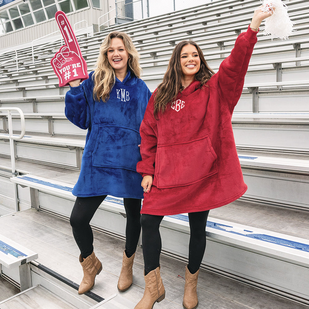 close up of girls wearing monogrammed blanket hoodies in crimson and blue