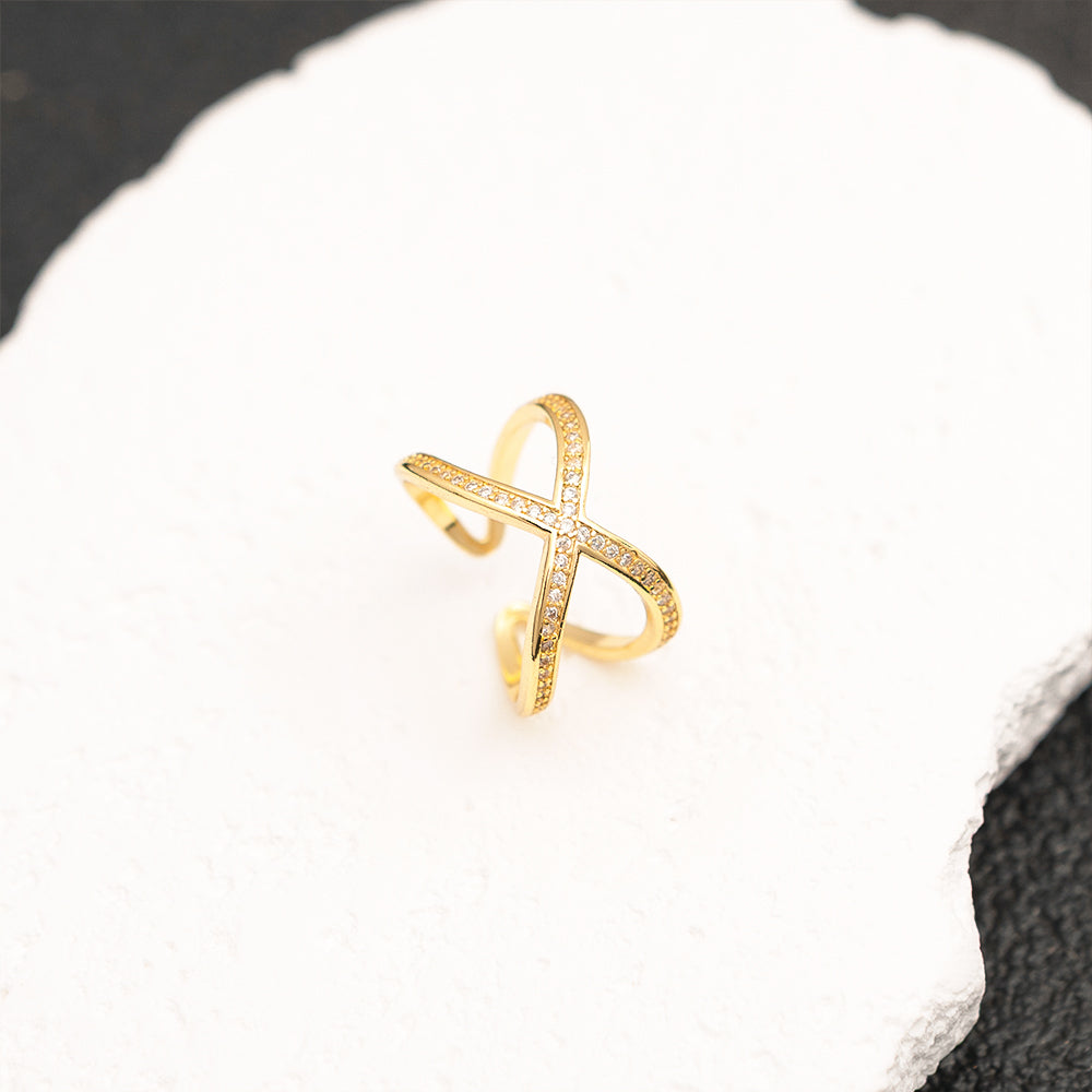 gold adjustable criss cross ring on white stone