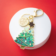 green Christmas bag charm keychain on red