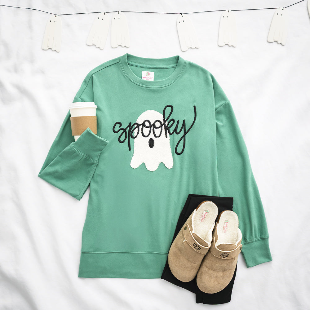 green spooky sweatshirt flatlay