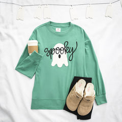 green spooky sweatshirt flatlay