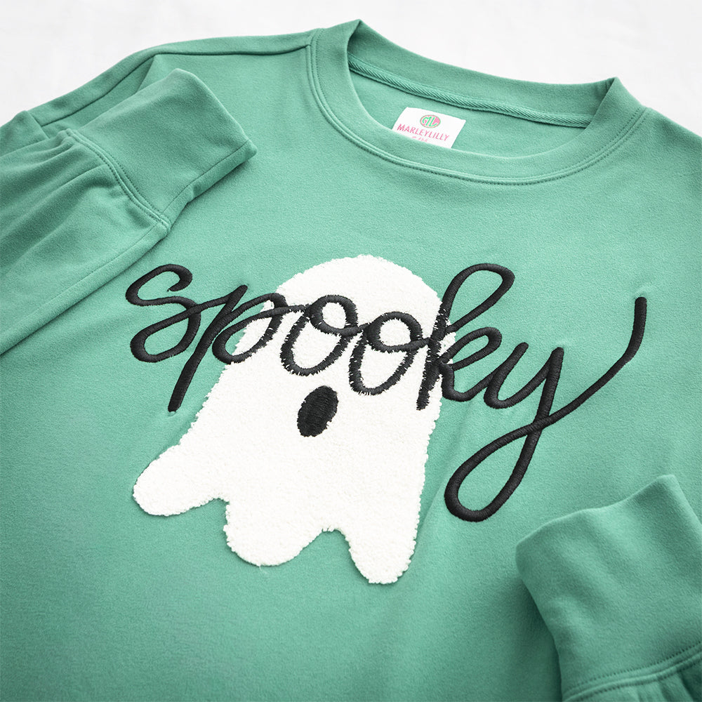 green spooky sweatshirt up close