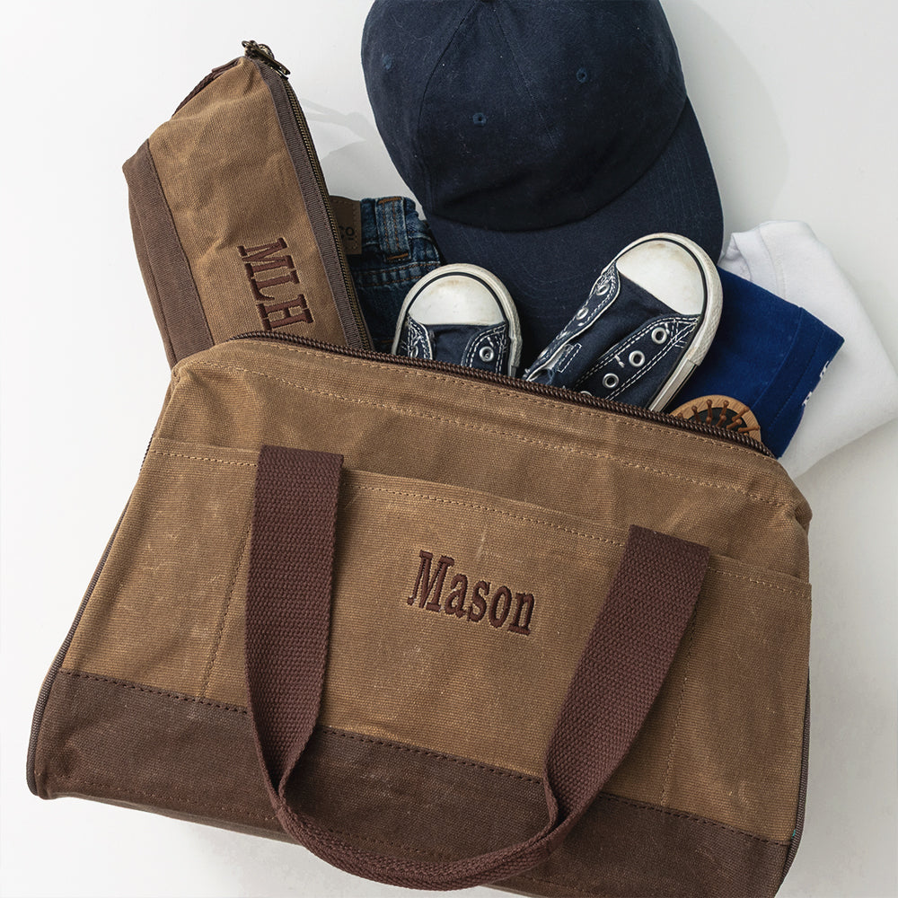 dark brown kids waxed canvas overnight bag flatlay