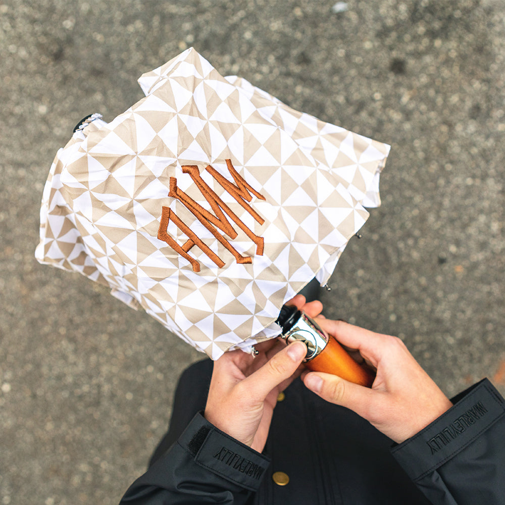 tan checker umbrella in hands