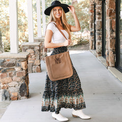 girl carrying monogrammed whipstitch brown purse over shoulder with midi skirt