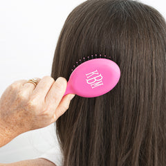 hot pink purse hairbrush in hair