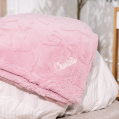 pink bow blanket on bed