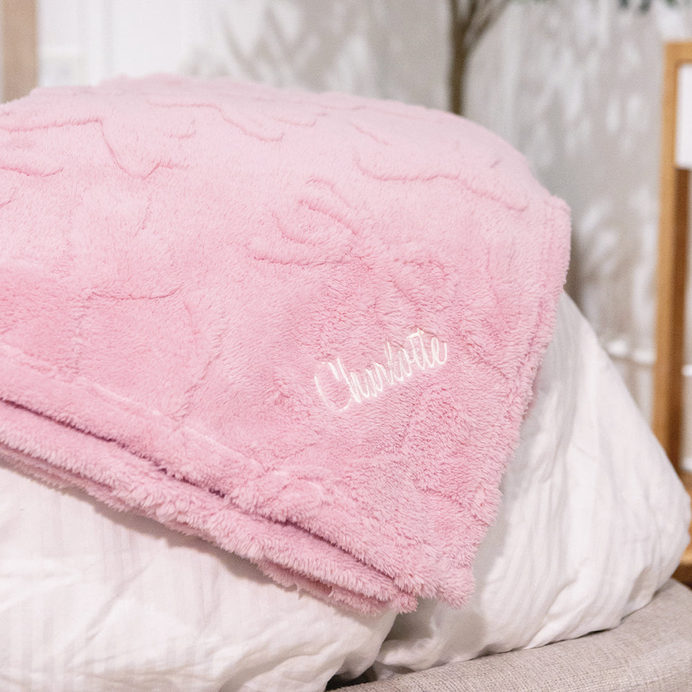 pink bow blanket on bed
