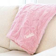 pink bow blanket on couch