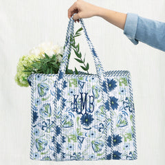 indigo painted petals monogrammed quilted tote bag on green seersucker background 