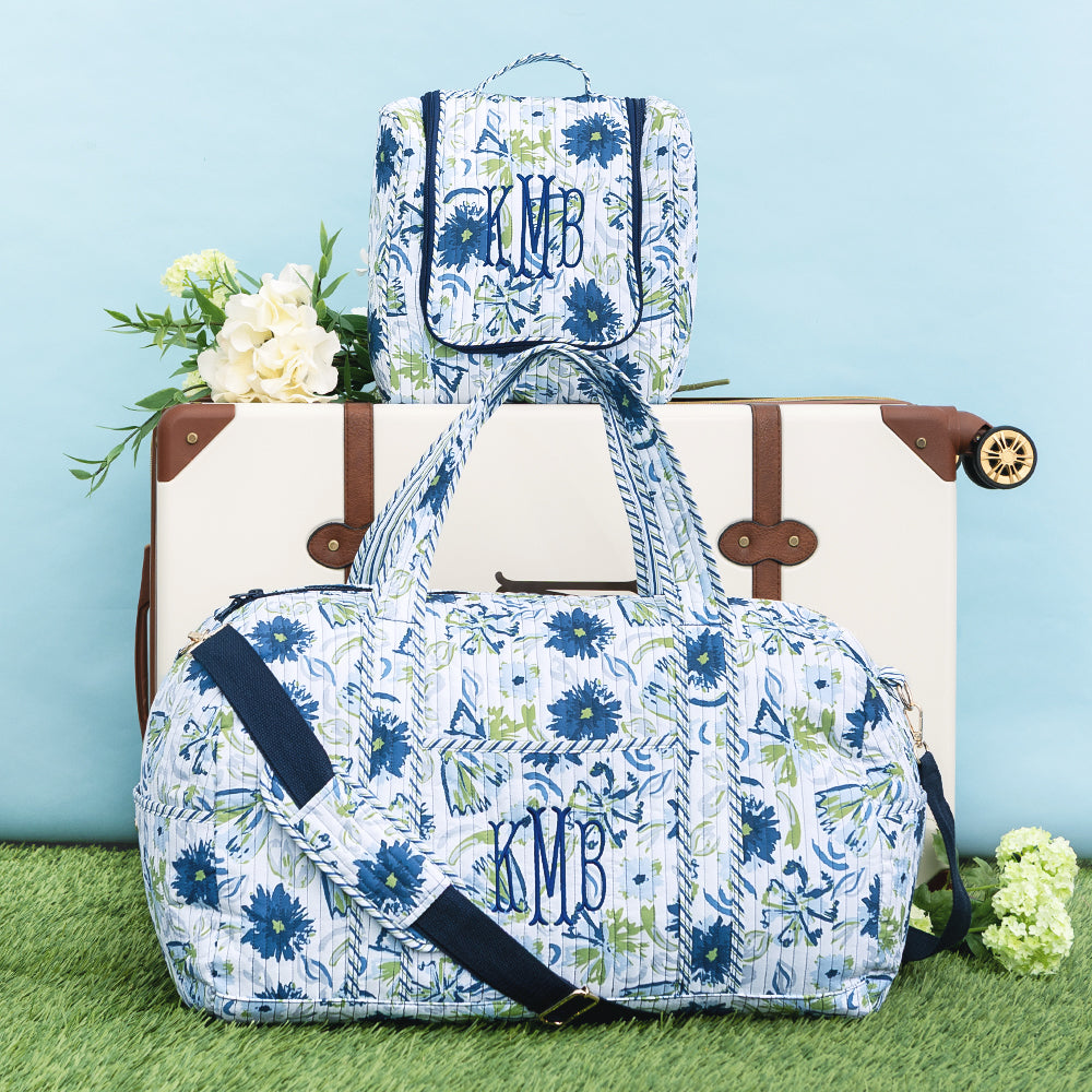 indigo painted petals monogrammed quilted weekender and hanging toiletry bag and luggage 