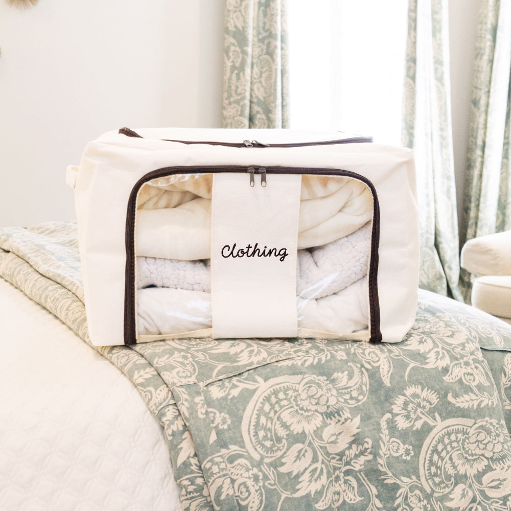 ivory monogrammed storage bag on bed 