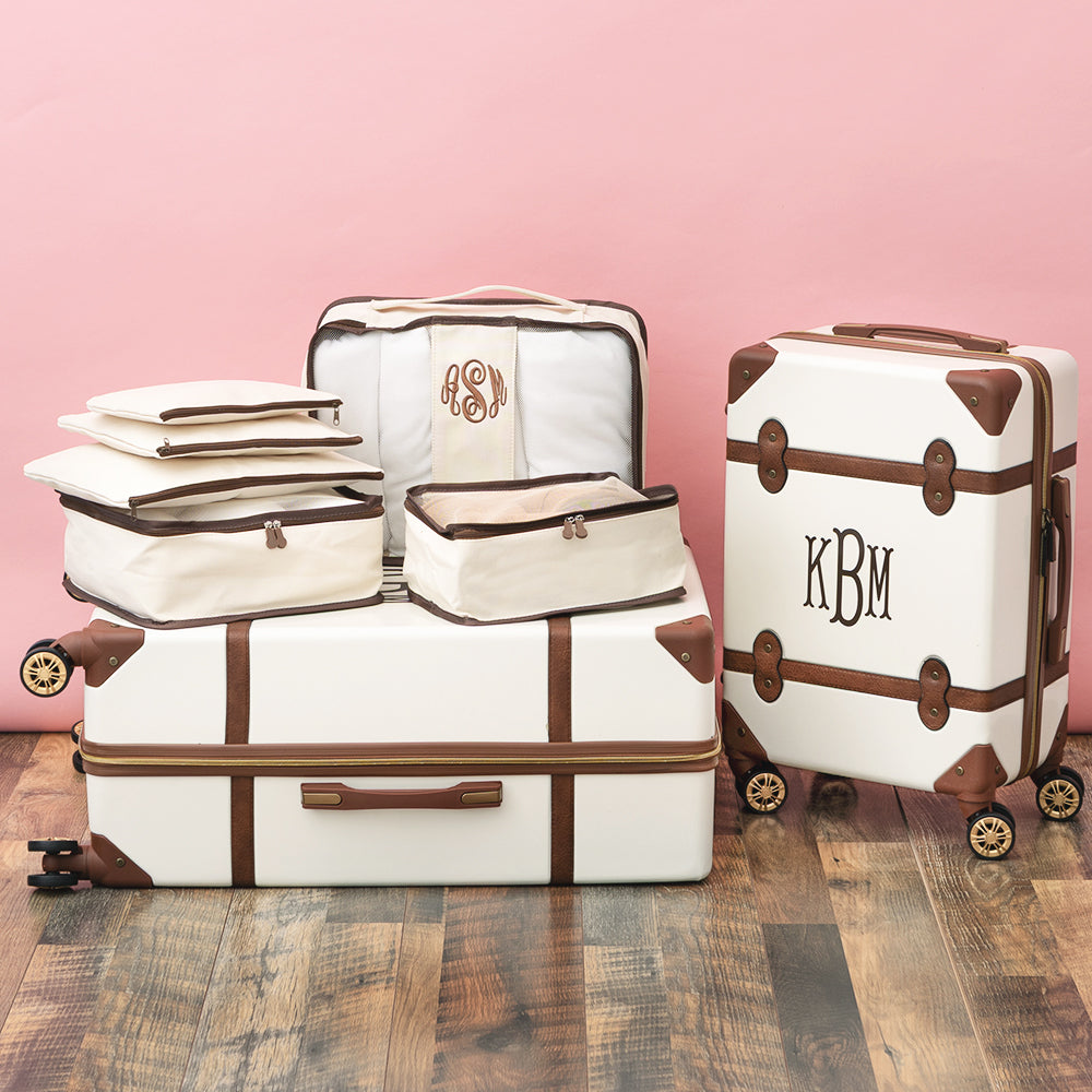 ivory monogrammed packing bag set on luggage 