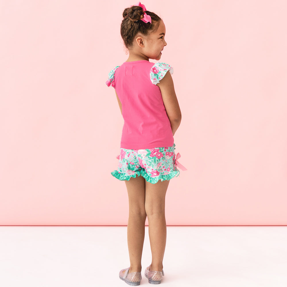 back of monogrammed girls ruffle short set in floral burst