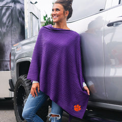 brunette leaning against truck wearing purple clemson poncho