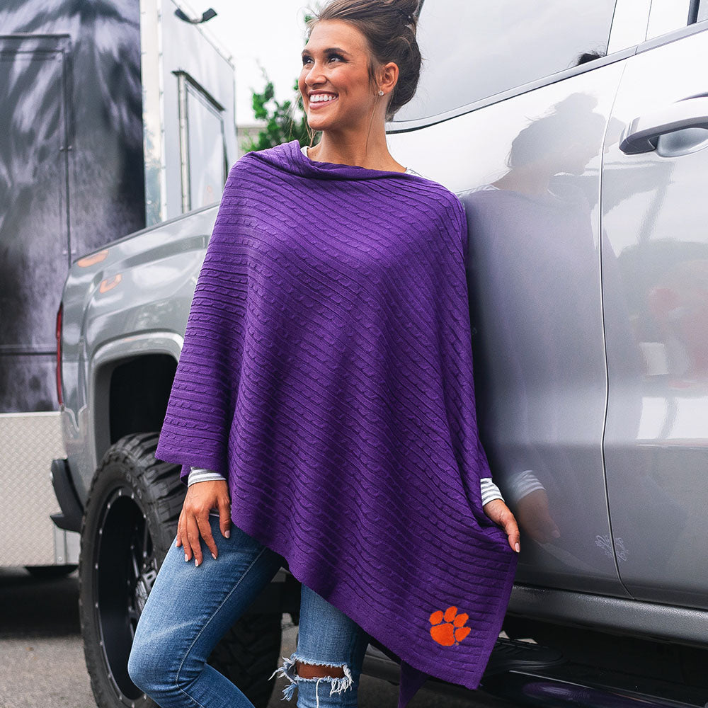 brunette leaning against truck wearing purple clemson poncho