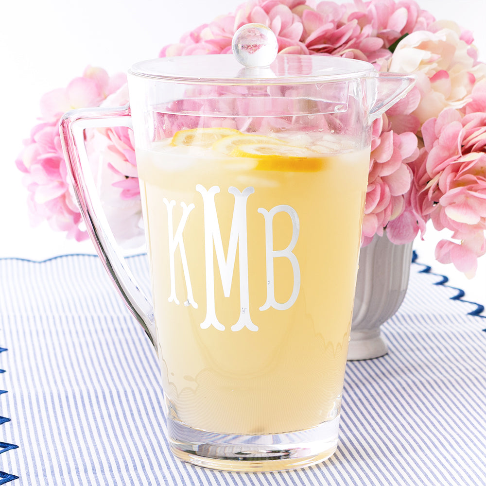 Clear acrylic pitcher with lemonade and flowers