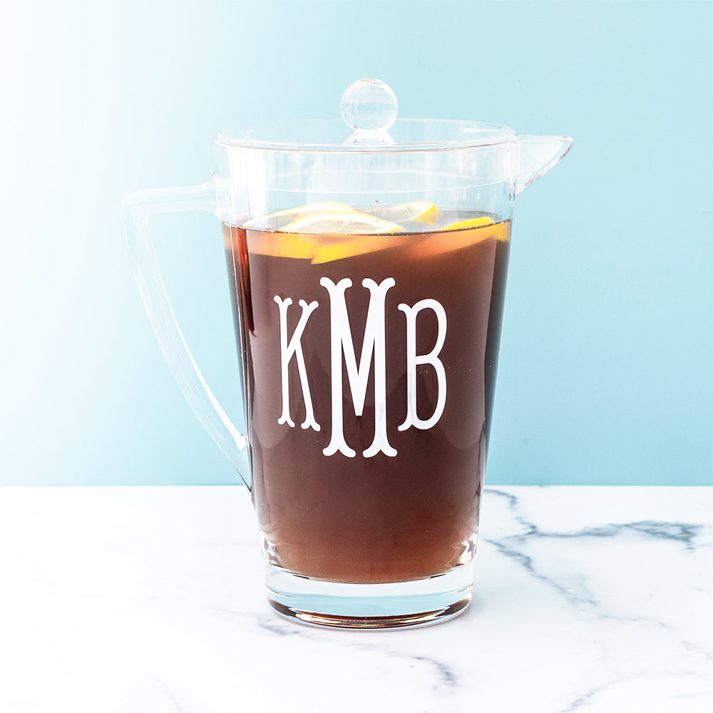 Clear acrylic pitcher with tea and blue background