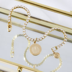 gold tennis bracelet reflected on mirror