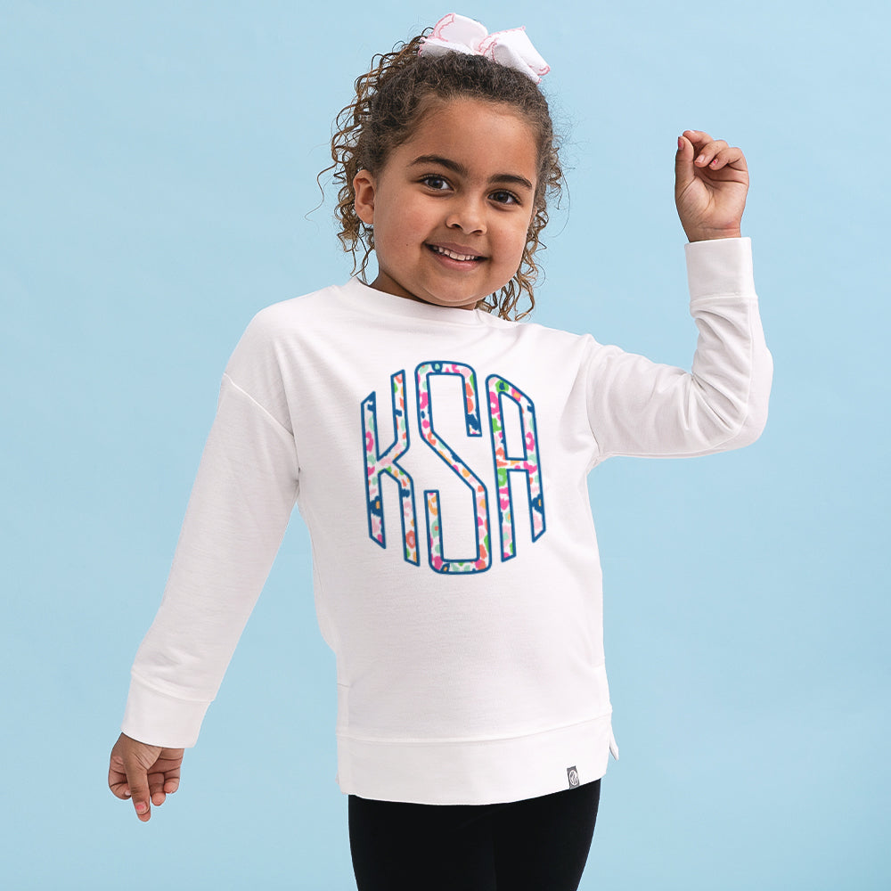 [aubri] girl wearing colorful leopard monogrammed kids crewneck sweatshirt close up