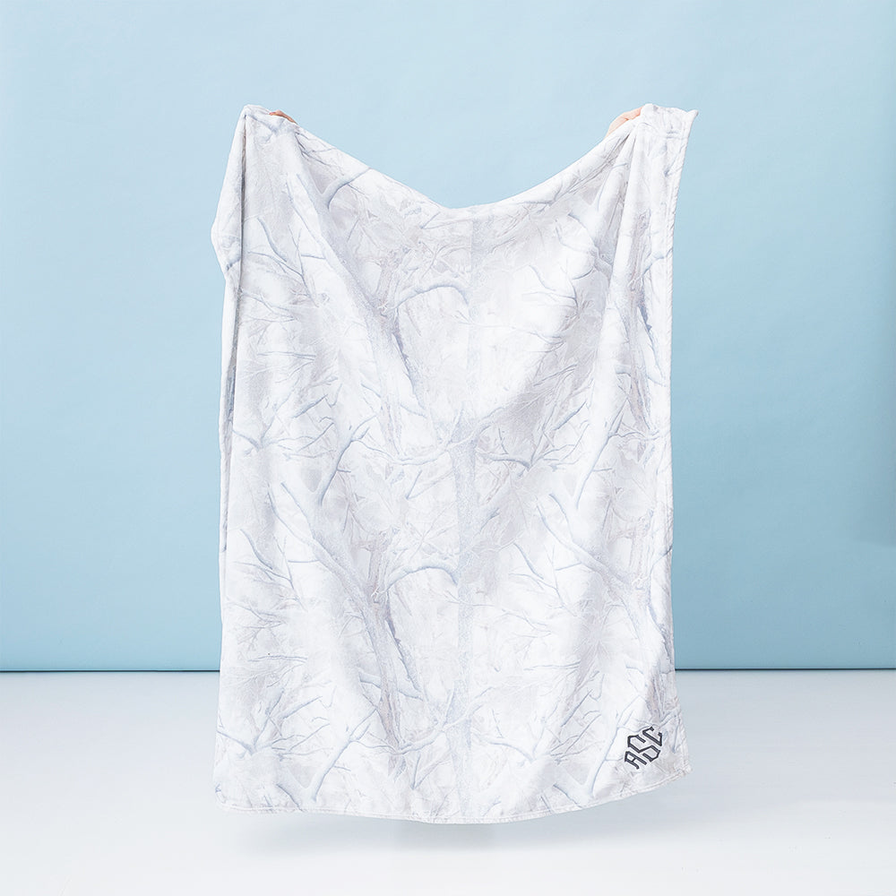 kids birch camo plush blanket held up by girl