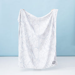 kids birch camo plush blanket held up by girl