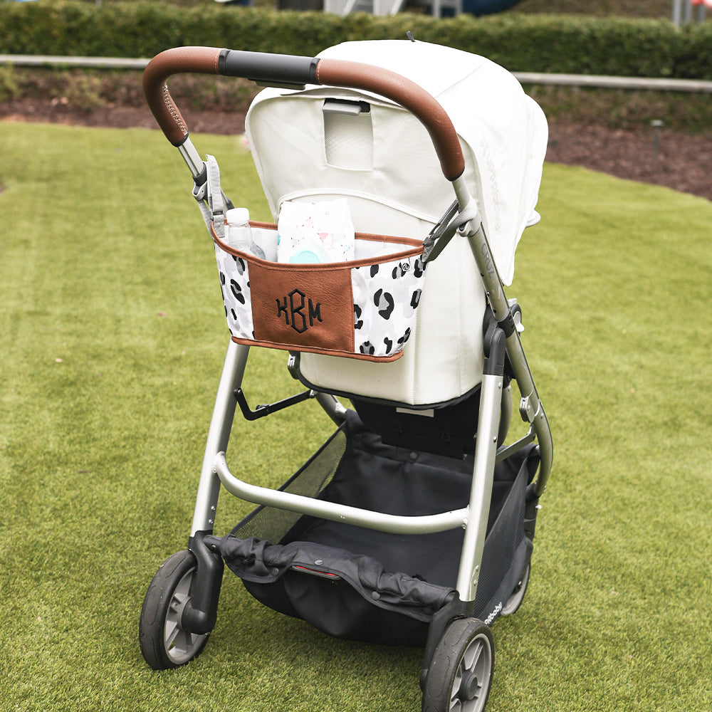 black sassy spots stroller caddy with stroller on grass
