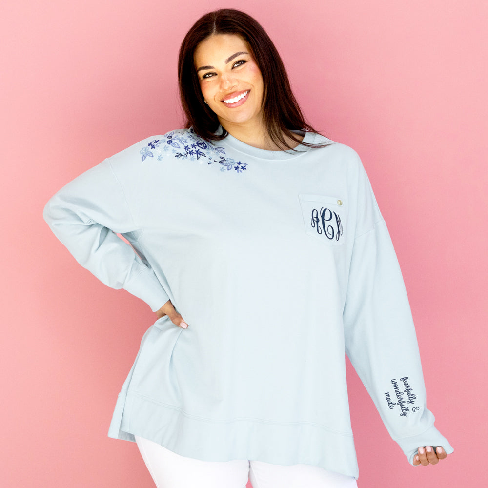 personalized ice blue faith sweatshirt in front of pink paper