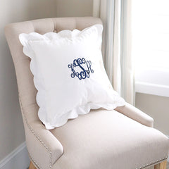 white scalloped pillow sham on chair