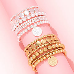 Lightweight bracelets in silver and gold on pink