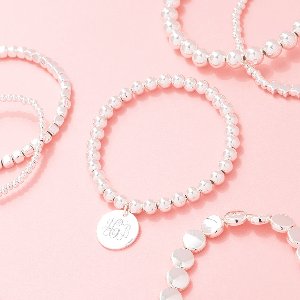 silver lightweight bracelets scattered on pink