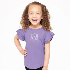 Child wearing a purple shirt with initials 'ASM' on a white background