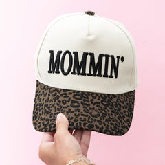 leopard mom trucker hat in hand