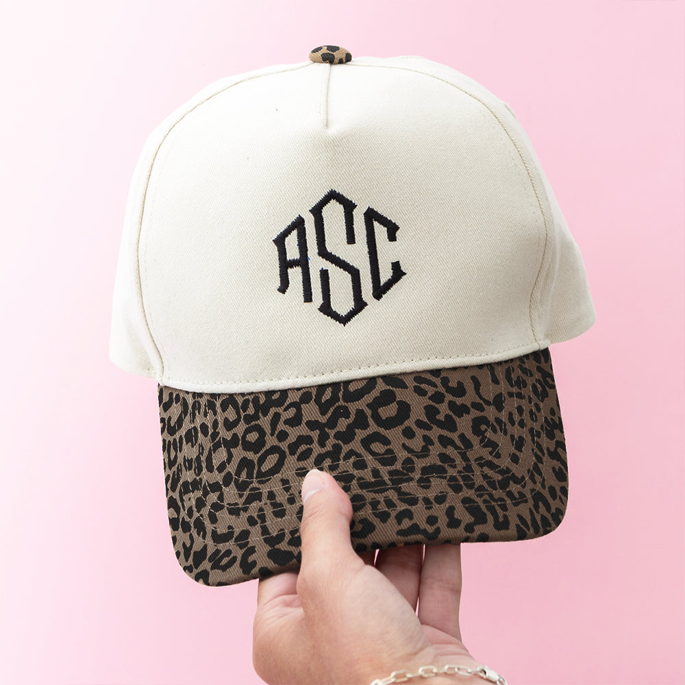 leopard trucker hat in hand