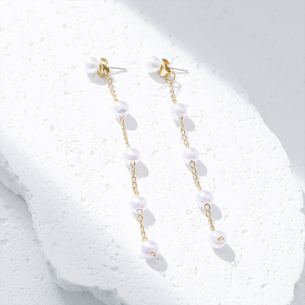 Pearl Duster Earrings on marble