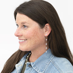 girl wearing pearl duster earrings